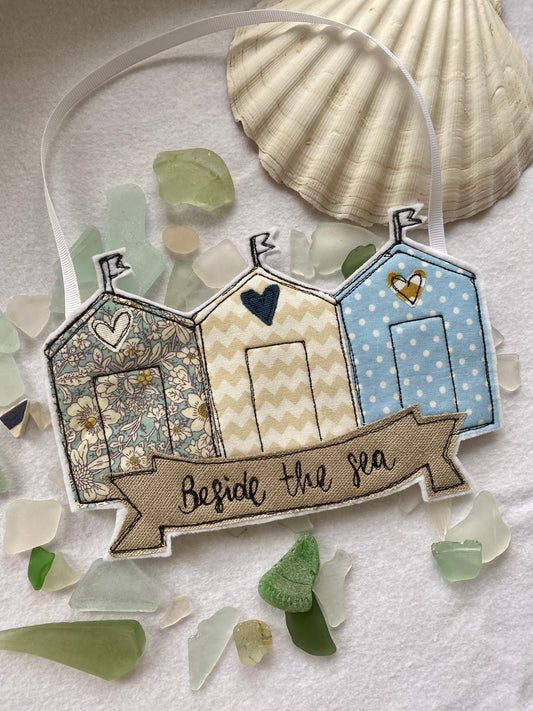 Beach huts beside the sea hanging decoration