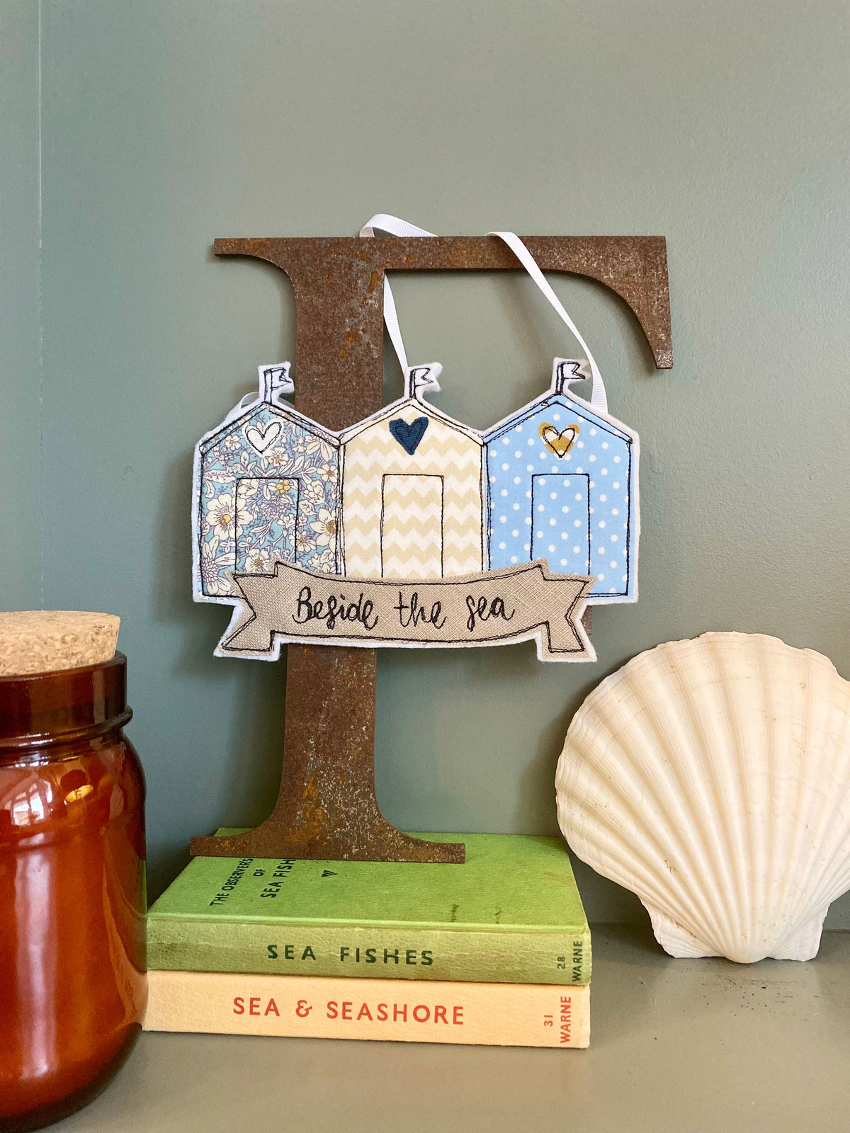 Beach huts beside the sea hanging decoration