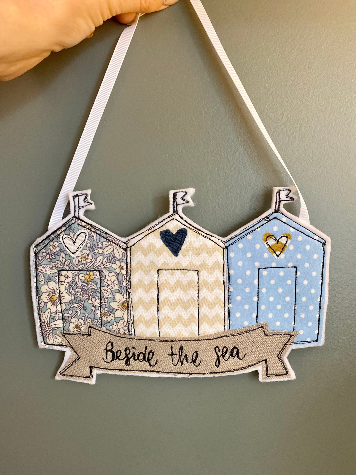 Beach huts beside the sea hanging decoration