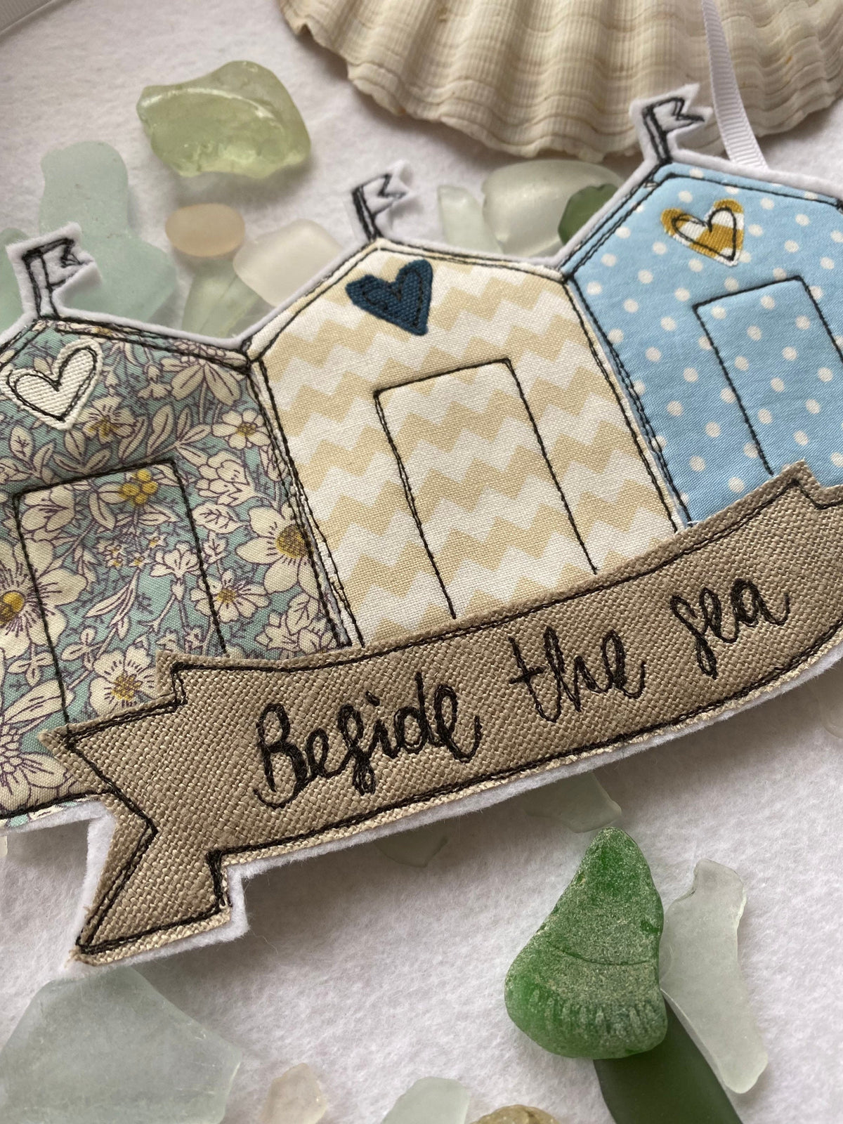 Beach huts beside the sea hanging decoration